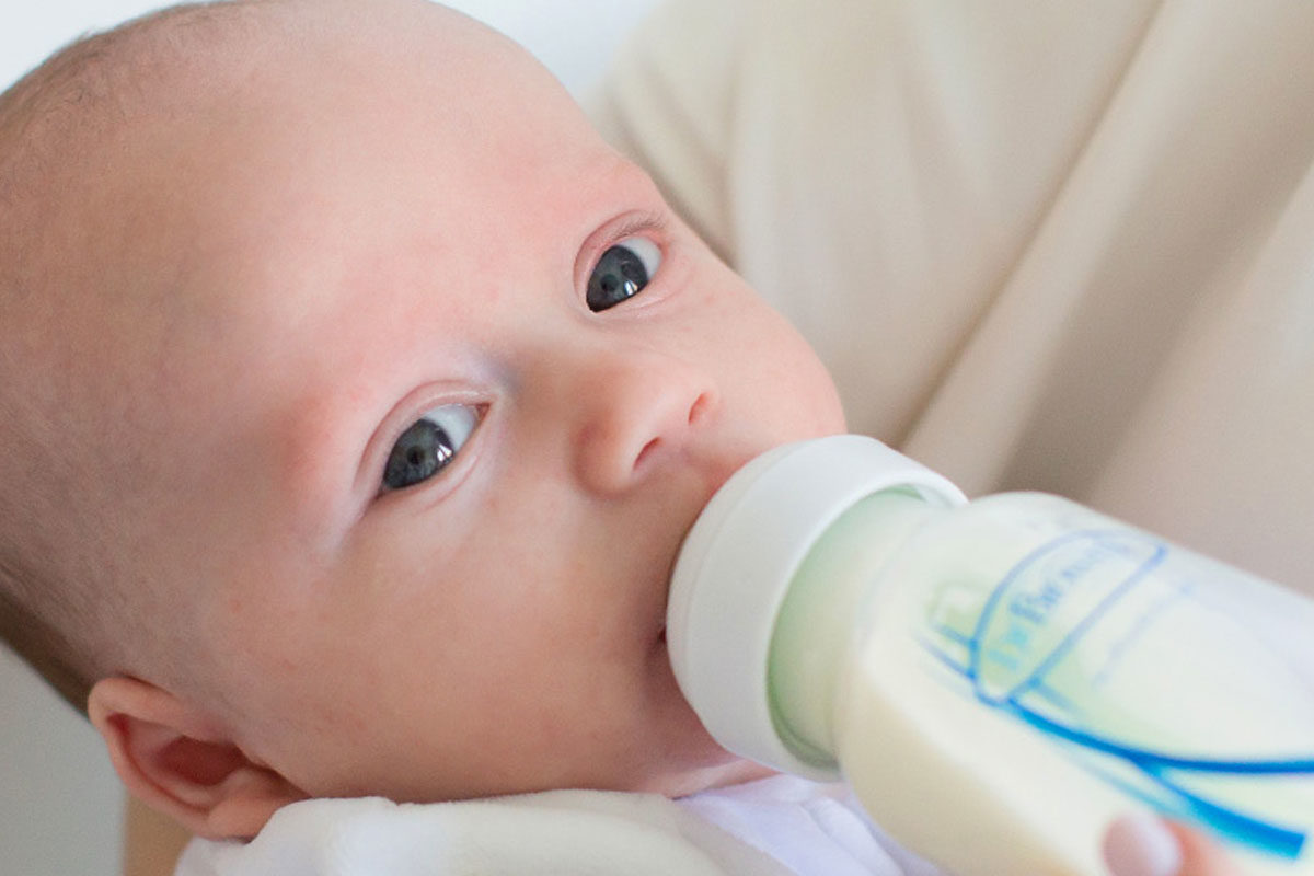Baby drinking from a Dr. Brown's bottle