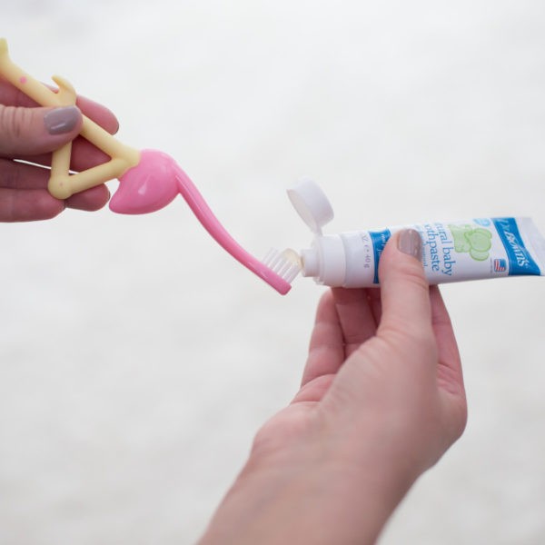 Toothpaste being put on a Flamingo Toothbrush