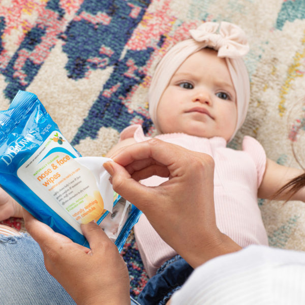 Dr. Brown's Nose and face wipe packaging next to baby