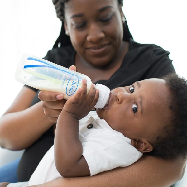 Mom feeding baby with Dr. Brown's Baby Bottle