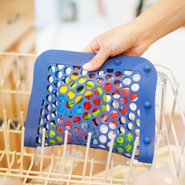Woman's hand putting dishwasher bag into dishwasher folded in half