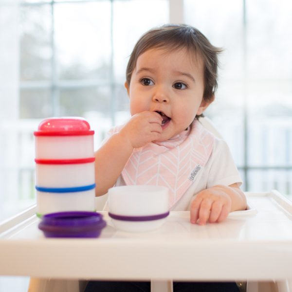 Toddler eating with Snack-a-Pillar Snack and Dipping Cups