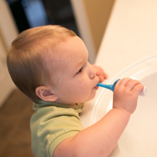 Baby in bathroom brushing teeth