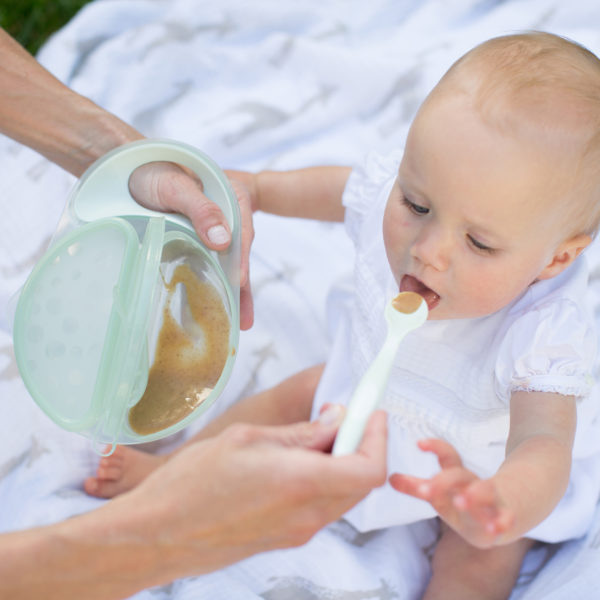 Mom feeding baby from TravelFresh Bowl and Spoon