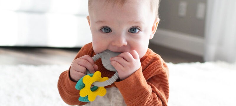 Baby chewing on a Dr. Brown's teether ring