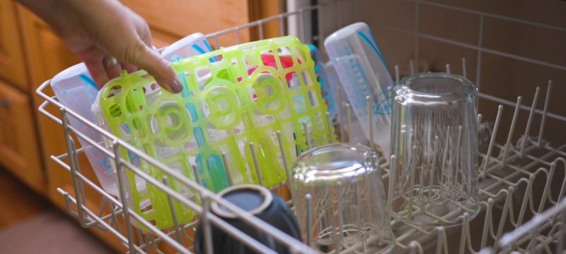 Dishwasher basket being put in full dishwasher