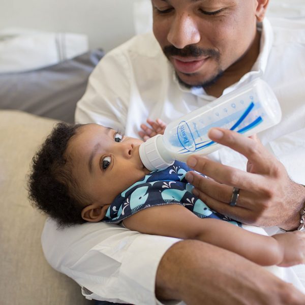father feeding baby son with a dr browns natural flow bottle