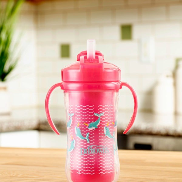 Photo of pink insulated straw cup with lid open sitting on kitchen counter
