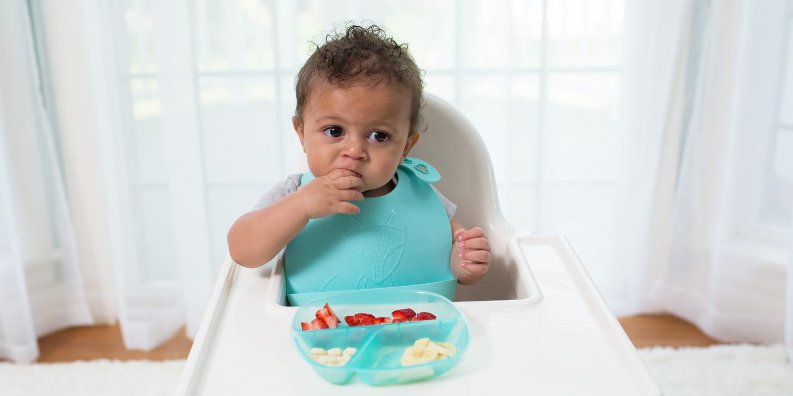 baby_eating_in_high_chair_with_Dr._Brown's_Divided_Plate_and_Silicone_Bib