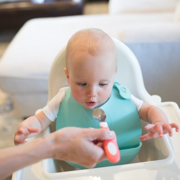 Mom feeding baby with Coral soft grip spoon