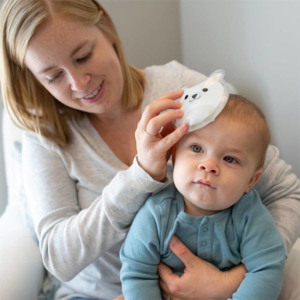 Woman using a Polar Bear Cold Compress on baby