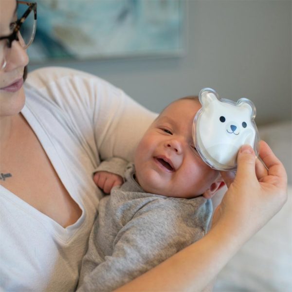 Woman using a Polar Bear Cold Compress on baby