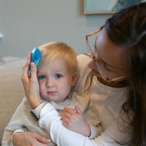 Woman using a Whale Cold Compress on baby