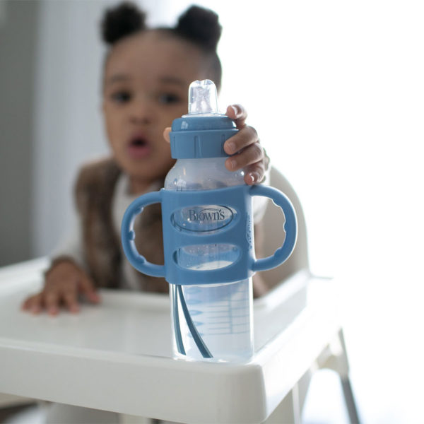 Toddler with a Light Blue Milestones™ Narrow Sippy Bottle