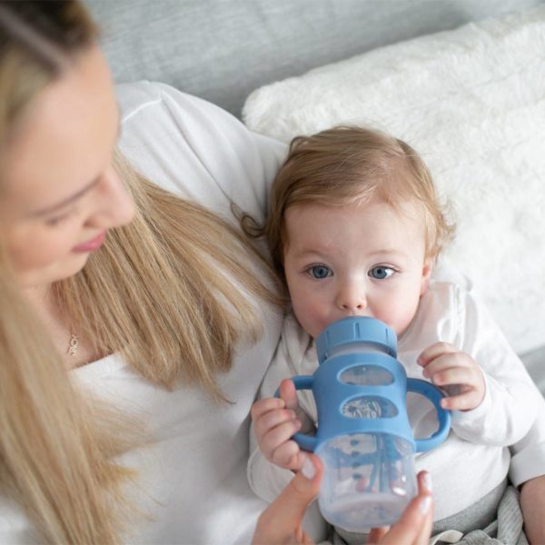 Parent with a toddler holding a Light Blue Milestones™ Wide-Neck Sippy Bottle with Silicone Handles
