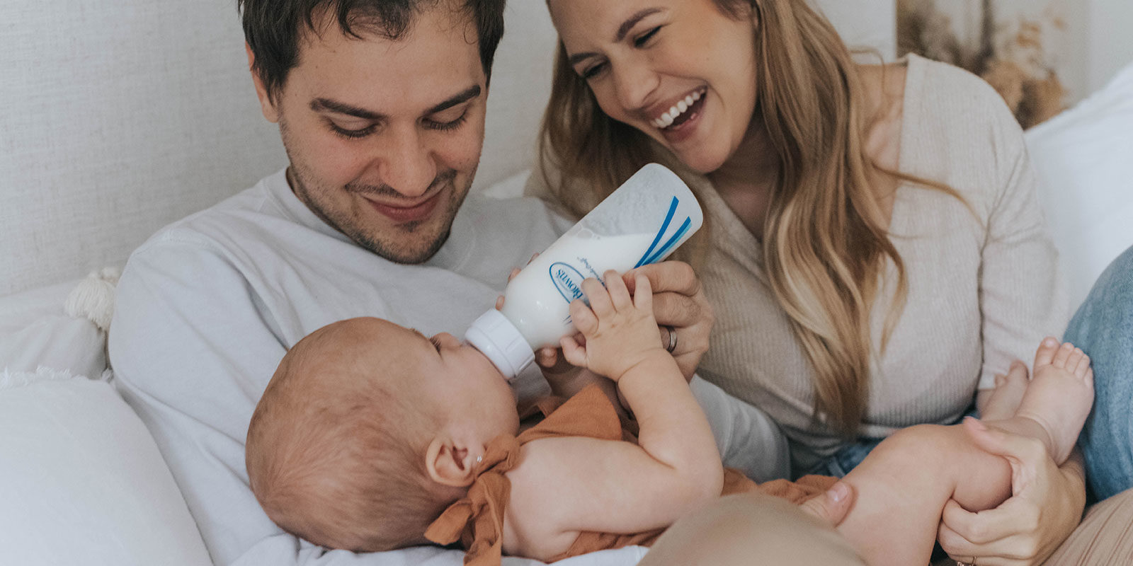 Anti-colic bottle feeding mom, dad, and baby