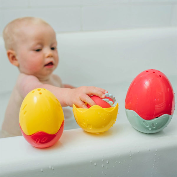 Baby playing with Float and Hatch Dino Egg bath toy