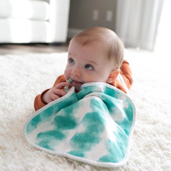 Infant with a green Lovey Blanket and teether