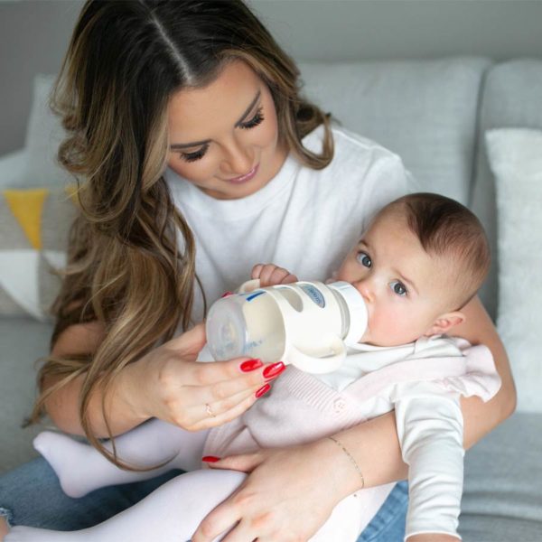 Parent feeding baby with a sippy bottle with ecru Wide-Neck Silicone Handles