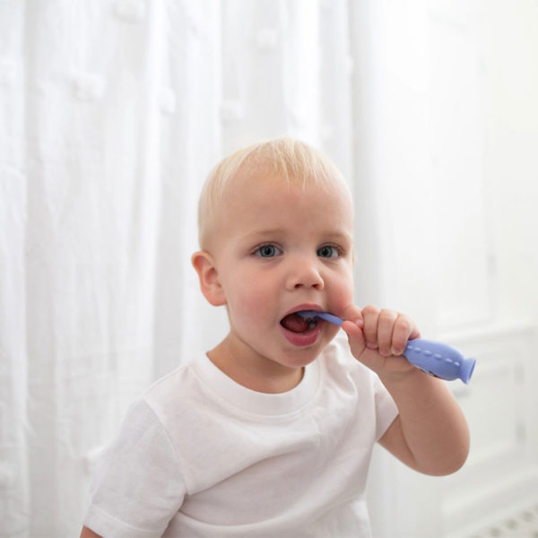 Toddler using a Toothscrubber™ Toddler Toothbrush