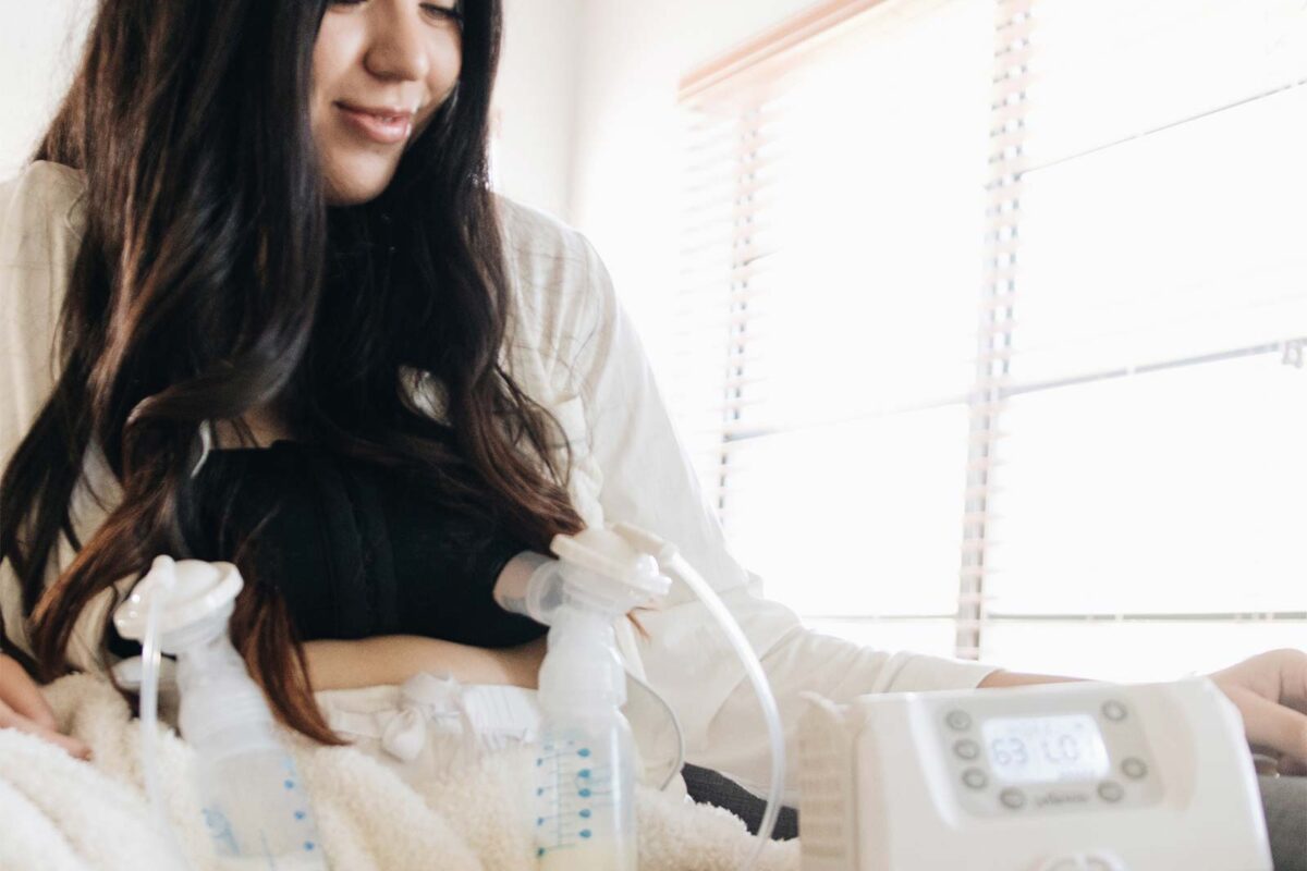 Parent with a Customflow Double Electric Breast Pump