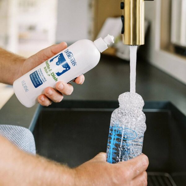 Person cleaning bottle with Bottle & Dish Soap