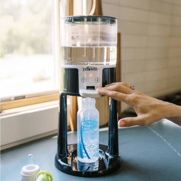 Person using Insta-Prep Warm Water Dispenser to fill bottle