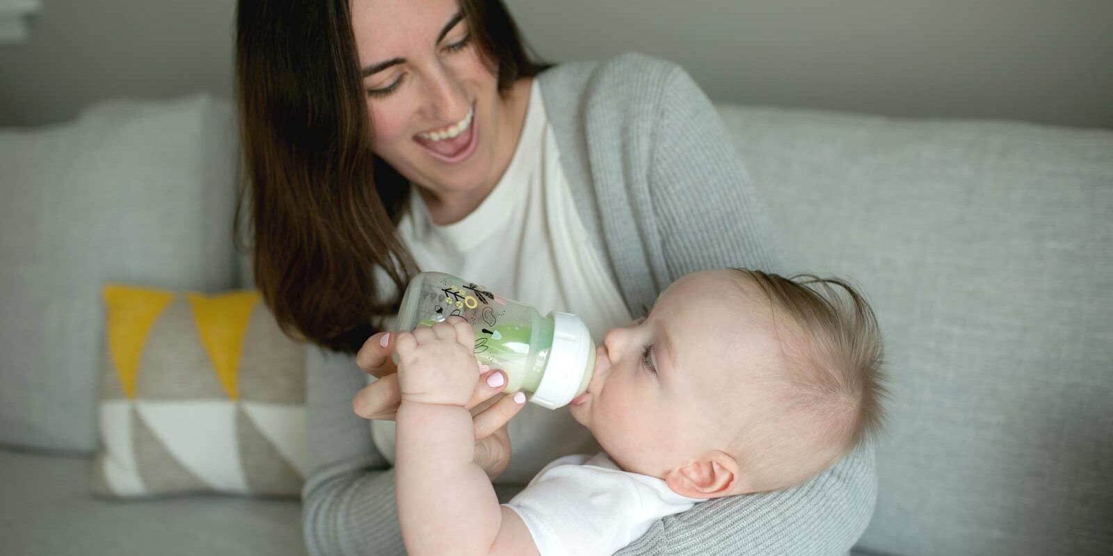 Parent feeding infant with Wide-Neck Bottle