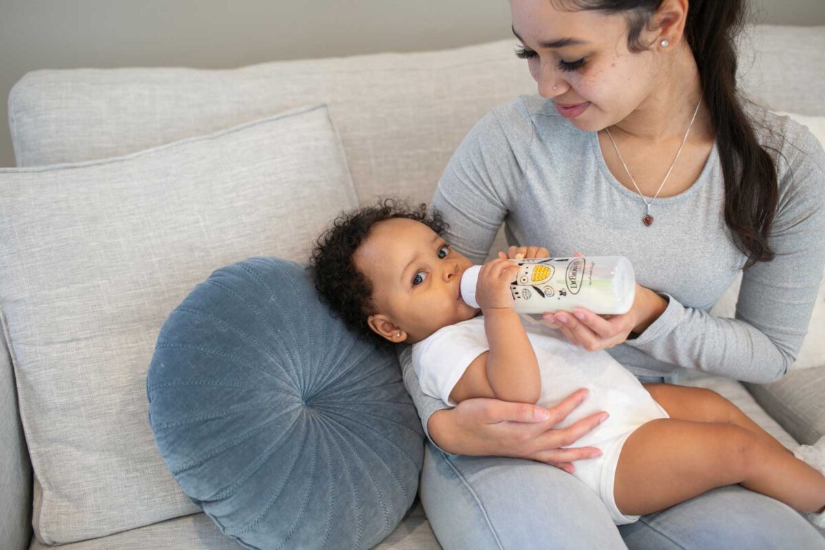 Parent feeding infant with bottle