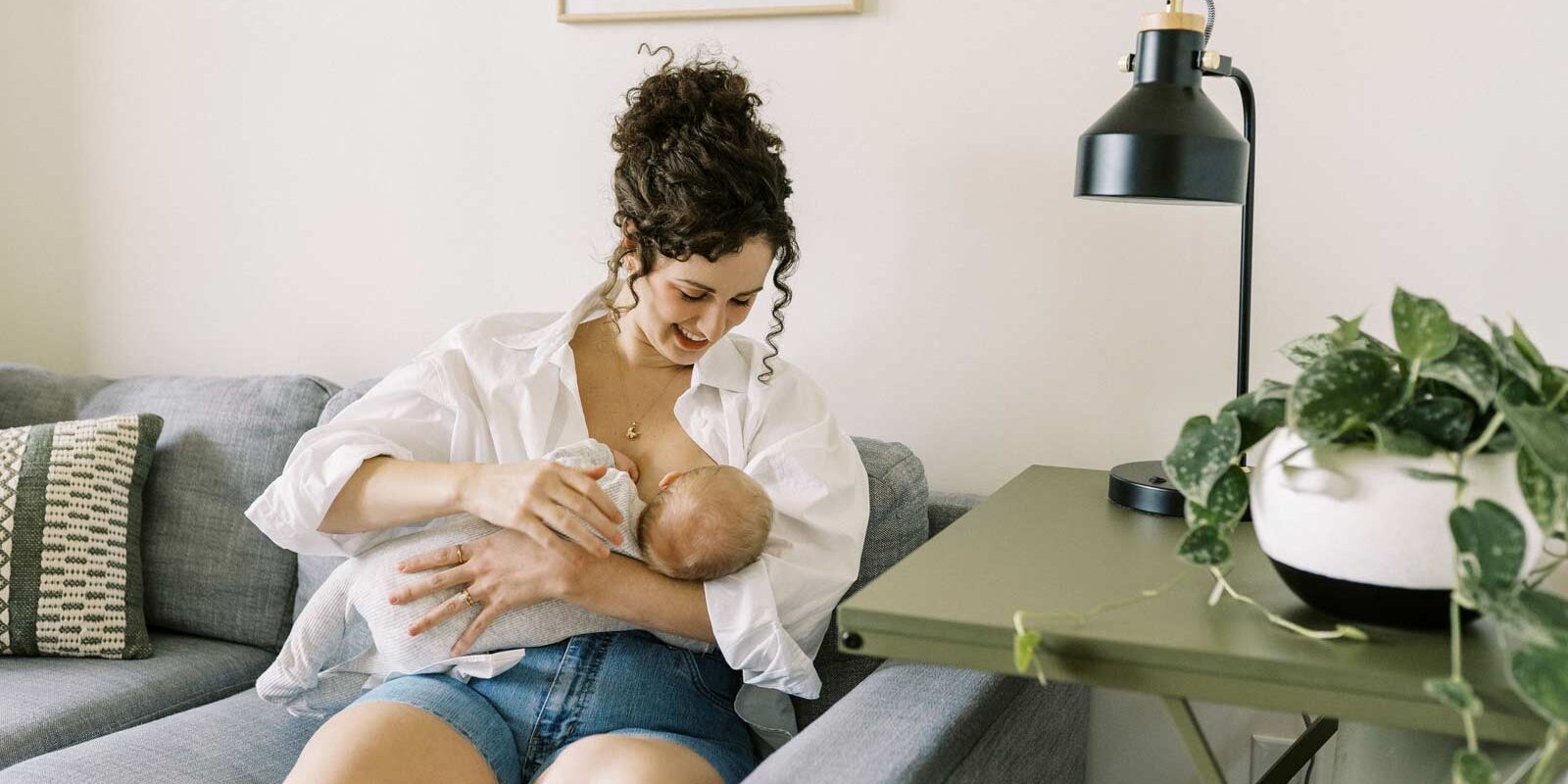 Parent breastfeeding newborn infant