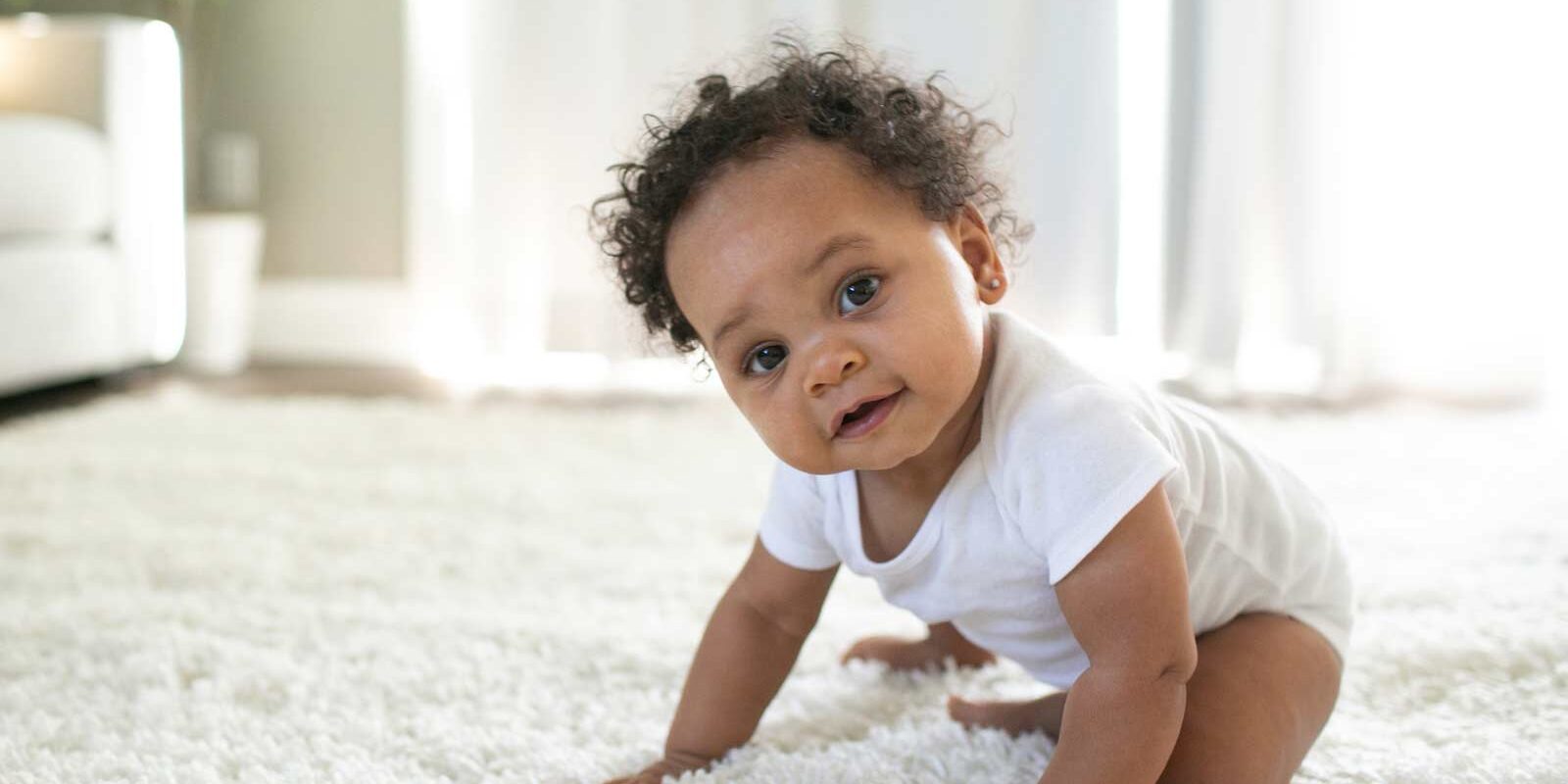 Baby crawling on carpeted floor